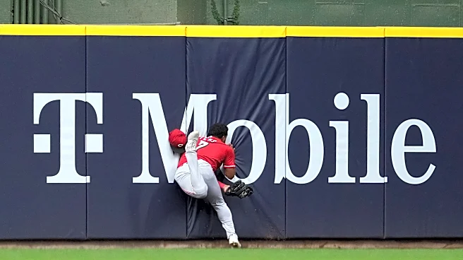 Reds' Dane Myers taken to the hospital after he crashed into the wall
