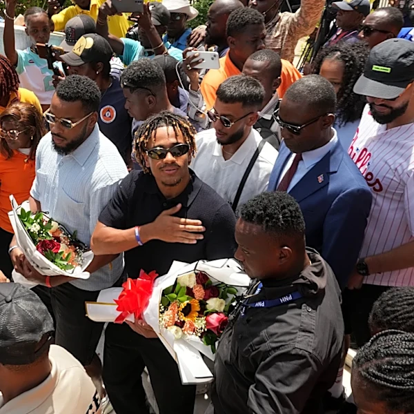 Members of Haiti's national soccer team tour their capital after playing in the World Cup