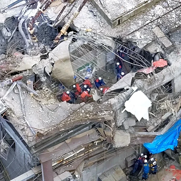 Rescuers search for survivors after a 7.1 quake kills 18 in southwestern Japan