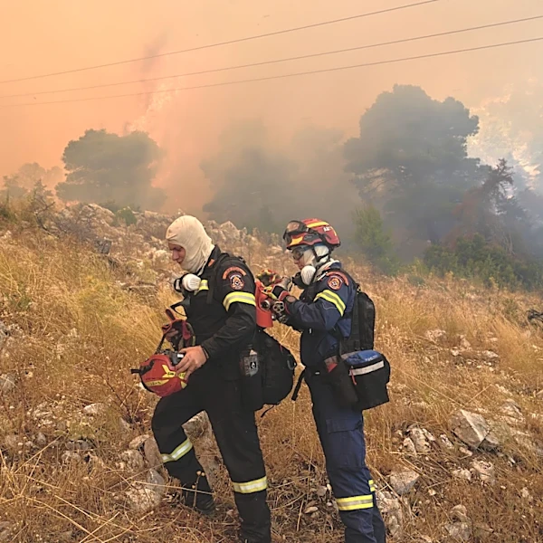 Firefighters scramble to contain fires outside Athens before winds and high temperatures return