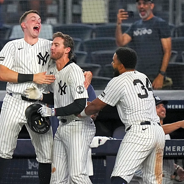 Yankees rally with 2 outs in 9th inning and beat Braves 3-2 in 10 after long rain delay