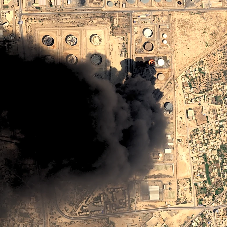 Drone strikes hit Libya's key western oil town and a car bomb kills an officer in the east