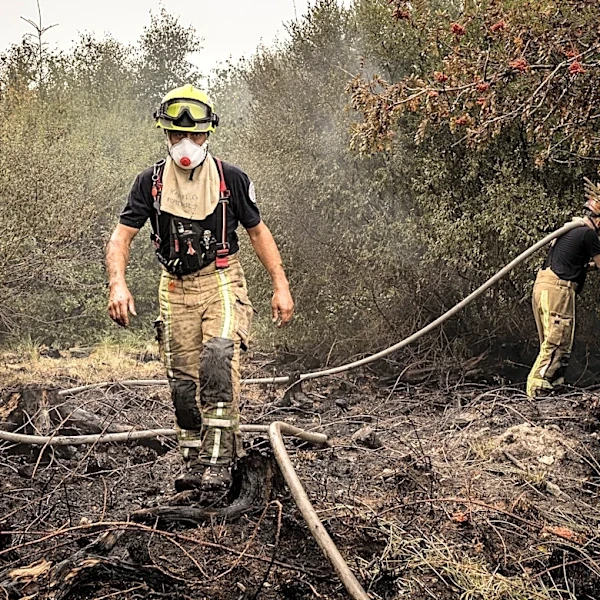 Firefighters battle wildfires in Belgium and Greece as 2 die on an island near Athens