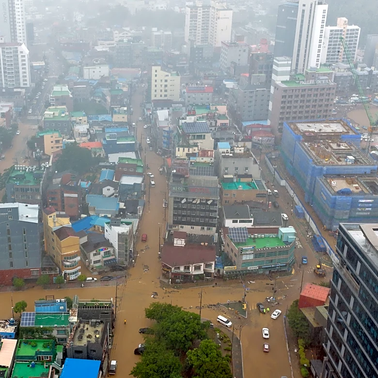 Heavy rains kill 1 in South Korea and flood major streets in Philippines