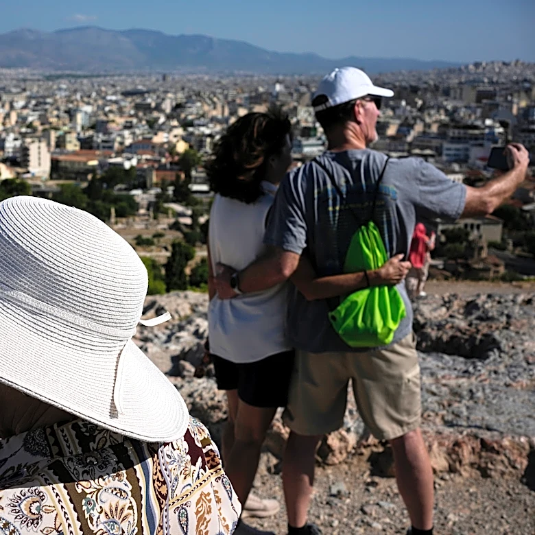 The sunhat is everywhere in Athens as crowds grow larger at ancient sites