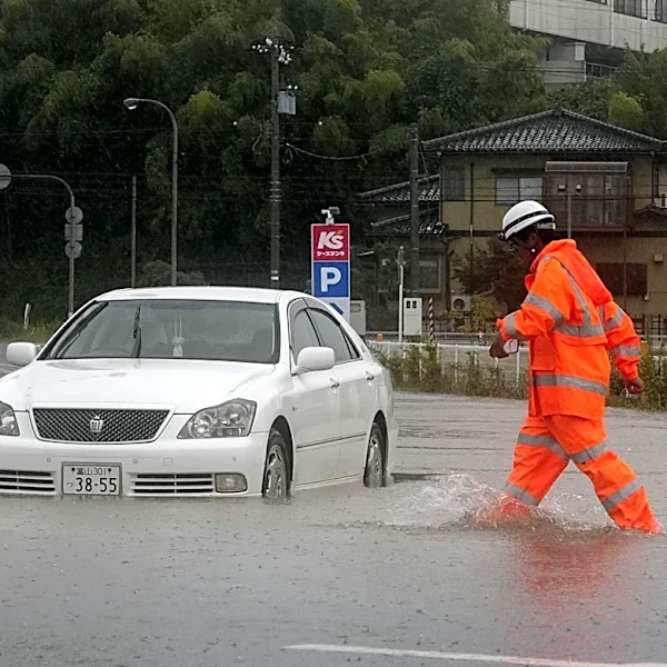 Heavy rain and flooding in north-central Japan strands people and vehicles