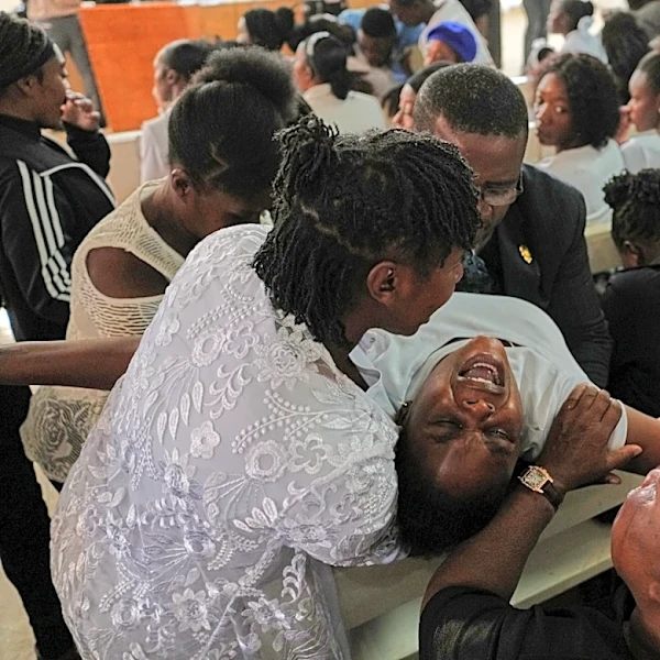 Mourners file into a church in Haiti where gangs killed dozens of people in latest rampage