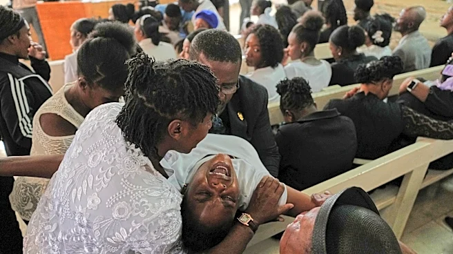 Mourners file into a church in Haiti where gangs killed dozens of people in latest rampage