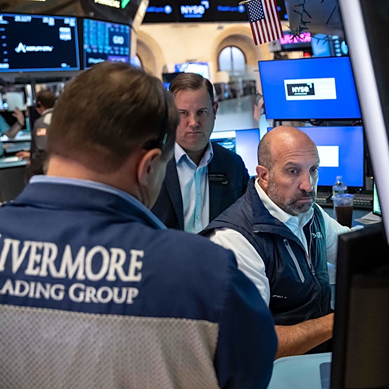 Stocks wobble after a surprisingly strong jobs report raises prospects of an interest rate hike