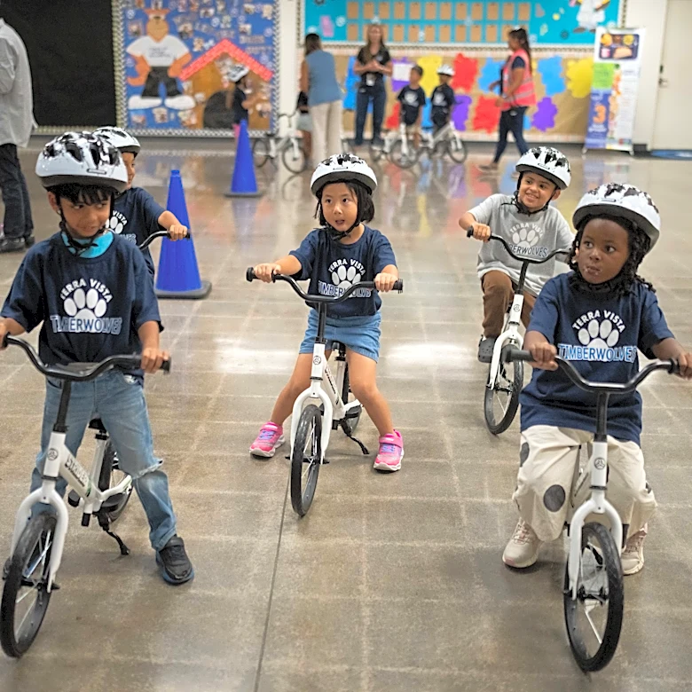 A childhood rite moves indoors as kindergartners learn to ride bikes in school gyms