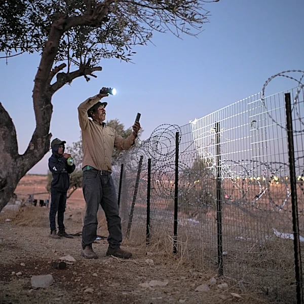 A flashlight and unseen settlers: Photographer conveys West Bank family's nightly watch in 1 photo