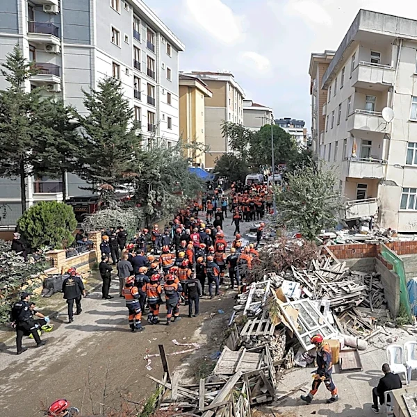 A partial building collapse in Istanbul kills 2 and traps at least 2 more