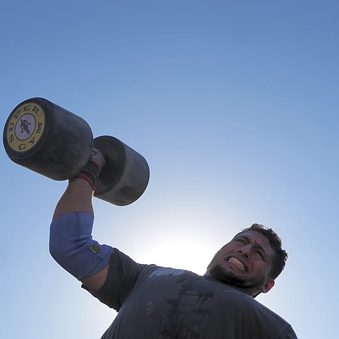 Burly men in Gaza pull trucks and flip tires in competition of strength