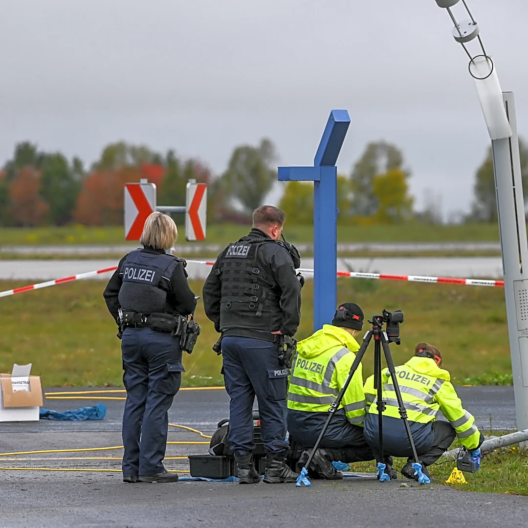 German police say 2 men turned themselves in after smashing their car into an airport fence