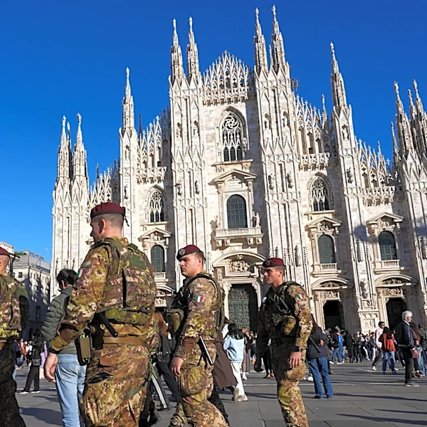Soldiers guard center of Milan as thousands of protesters march across European cities