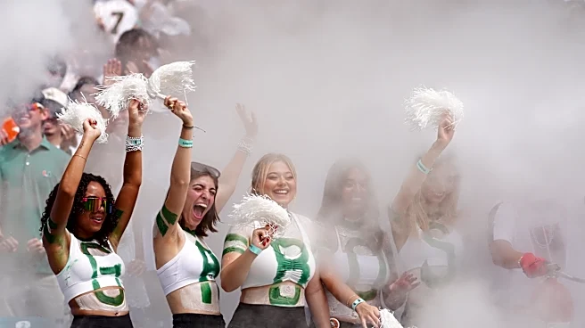No. 1 Miami, in its first game atop AP poll since 2002 season, rolls past Pitt 52-23