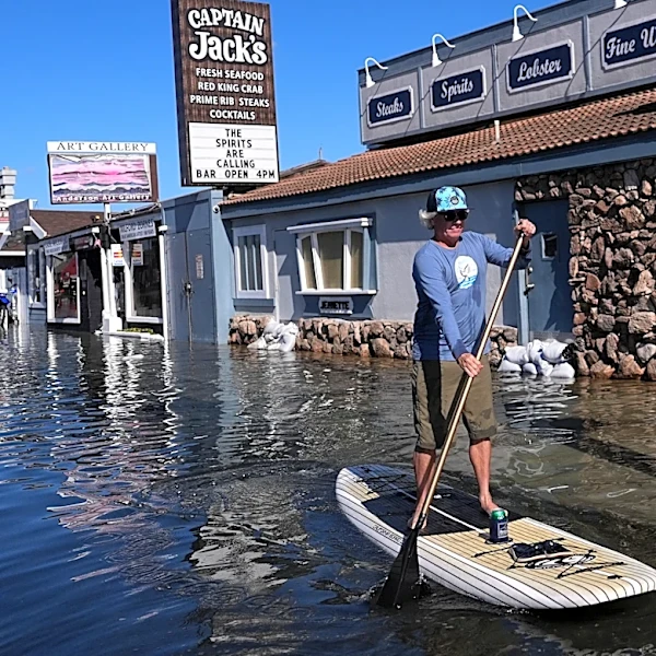 King tides inundate streets and flood homes and businesses along both US coasts