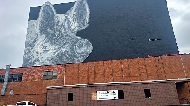 Who is the pig in the mural seen from US 50/Sixth Street? Just Askin'