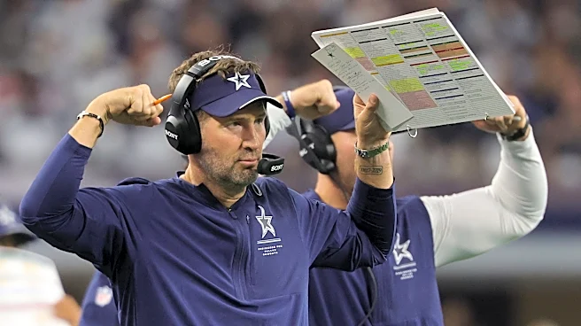 Cowboys coach Brian Schottenheimer acknowledges Jayden Daniels' injury after the game