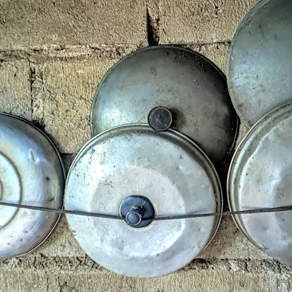 Turn Old Pot Lids Into The Cutest Rustic Porch Wind Chime