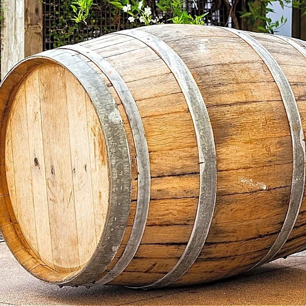Man Turns An Old Wine Barrel Into A Cheaper DIY Pond That Adds A Rustic Touch