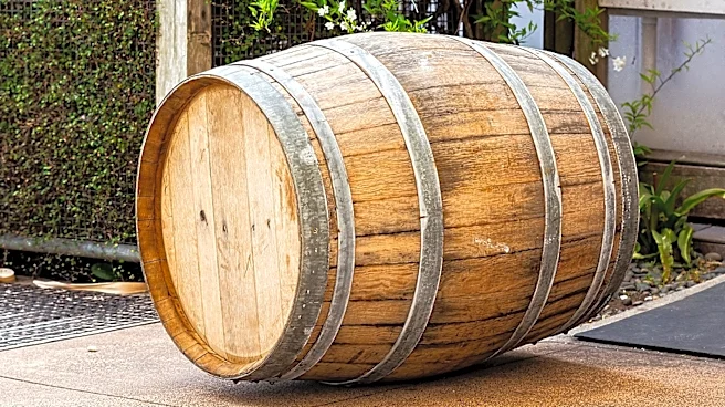 Man Turns An Old Wine Barrel Into A Cheaper DIY Pond That Adds A Rustic Touch