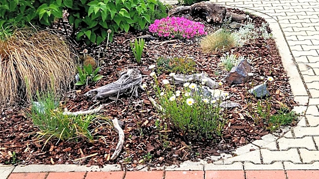 Give Mulched Garden Bed Edging A Rustic Touch With A DIY That Uses River Rocks