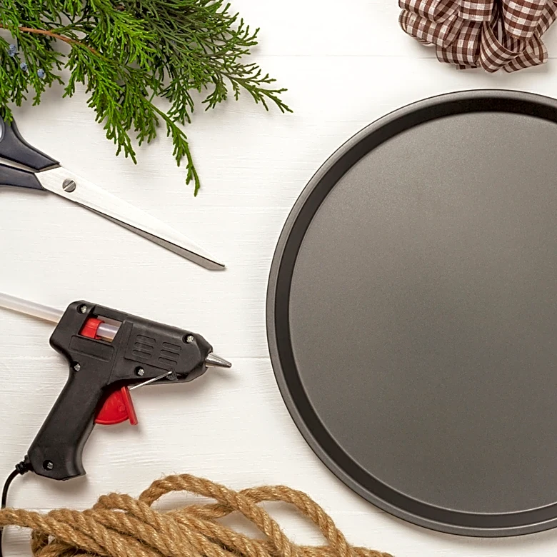 Use Paper Towel Holders To Transform A Dollar Tree Pizza Pan Into A Functional Plant Stand