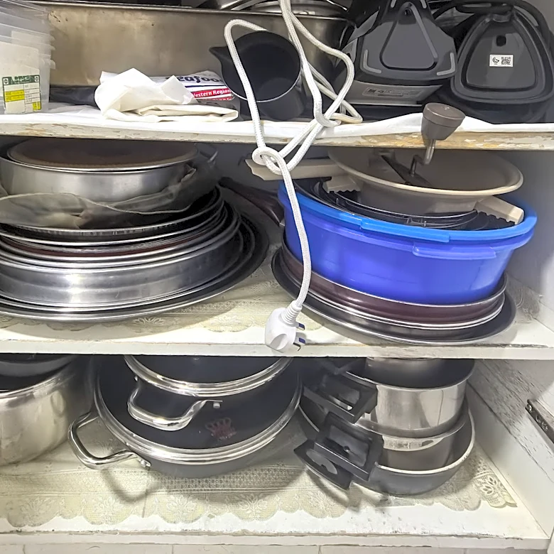 Goodbye Cluttered Cabinets: Store Old Pot Lids With A Wire Hanger Hack
