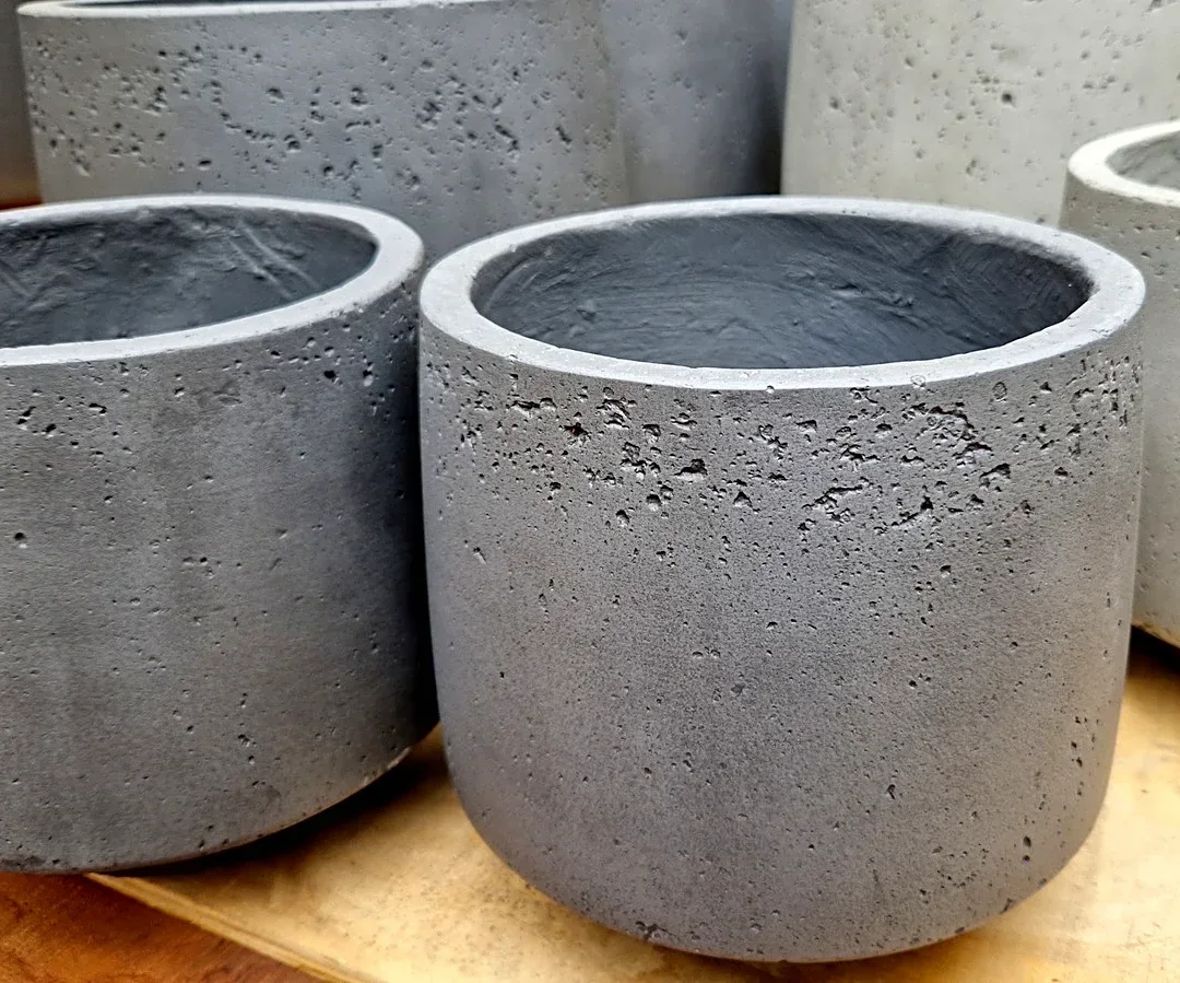 He Uses Cement And A Laundry Hamper To Make Tall Planters With An Impressive DIY