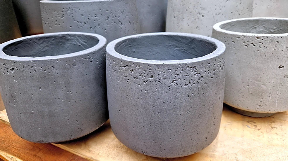 He Uses Cement And A Laundry Hamper To Make Tall Planters With An Impressive DIY