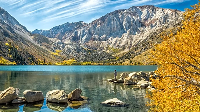 Tucked Beneath California's Soaring Cliffs Is A Mirror-Clear Lake With Golden Aspens And Alpine Trails