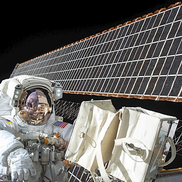 NASA Astronaut Chris Williams Flexes Muscles During Spacewalk on ISS