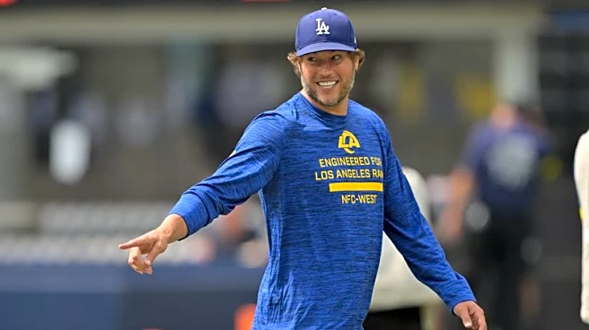 Rams QB Matthew Stafford (back) participates in first practice