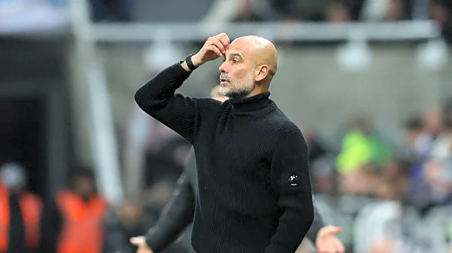 Soccer-Man City's Guardiola apologises for confrontation with cameraman