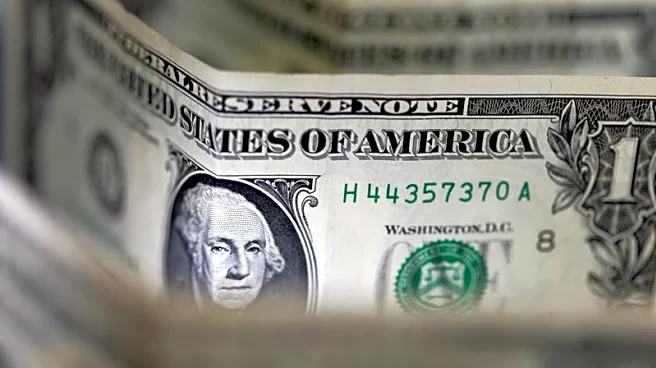 Dollar sinks to four-year low, Trump brushes off the decline