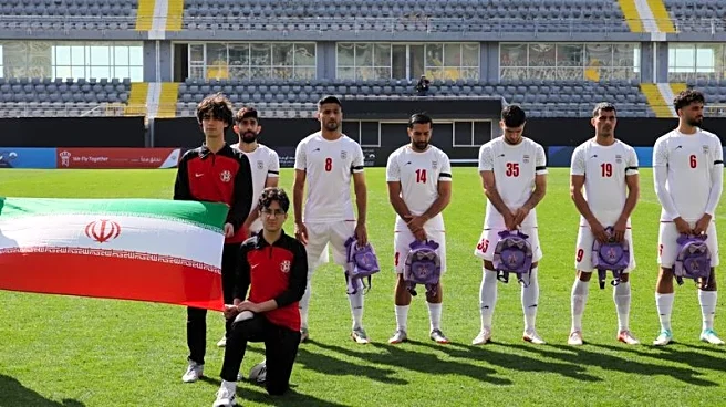 Soccer - Iranian players hold schoolbags in solidarity with slain girls