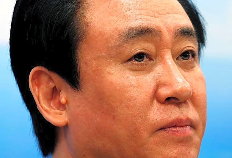 China Evergrande's billionaire boss falls from circles of power to fraud plea