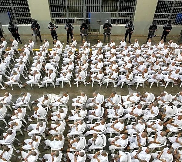 In El Salvador, shackled prisoners watch their mass trial on a big screen