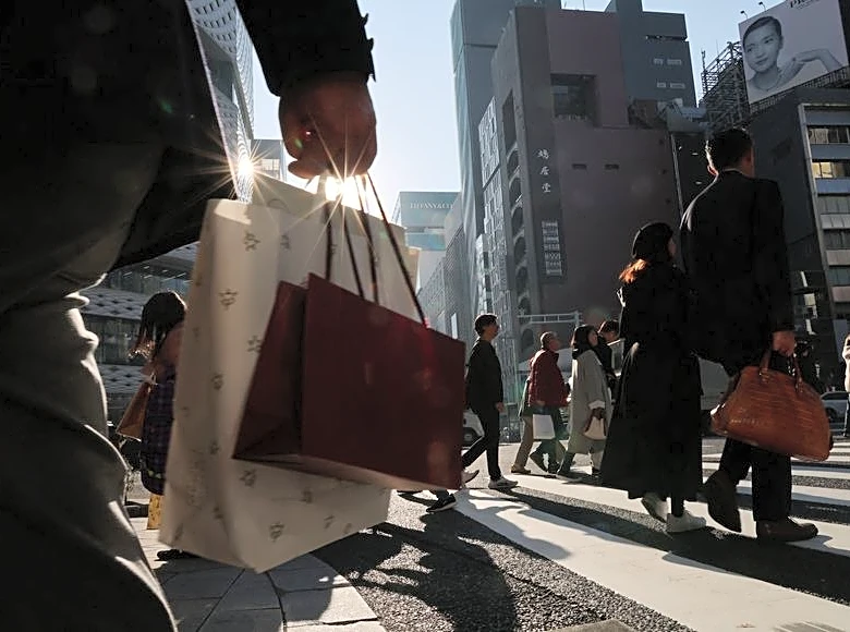 Japan keeps view economy recovering but warns risk from Middle East