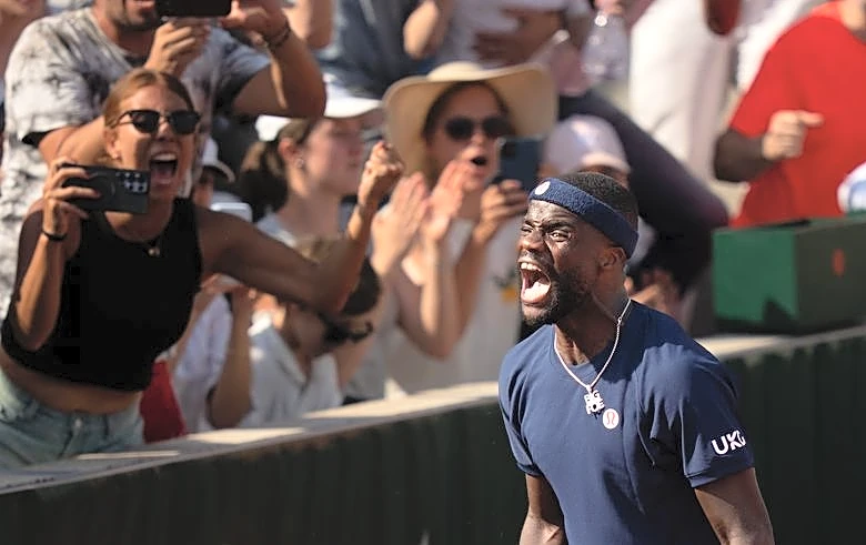 Tennis-Tiafoe makes online plea after losing racket in crowd during victory celebrations