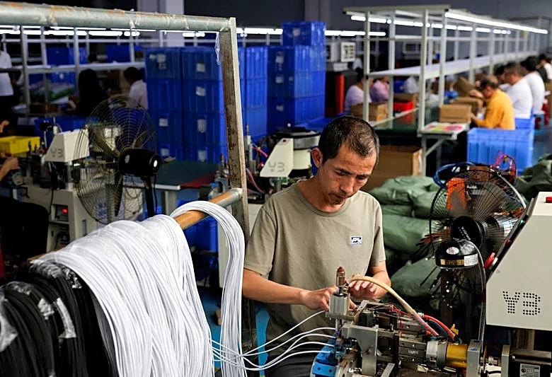 China May factory activity expands for sixth month as price pressures ease, private PMI shows