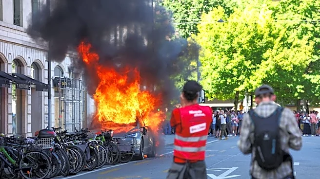 Protesters smash windows and set Tesla ablaze in anti-G7 march in Geneva