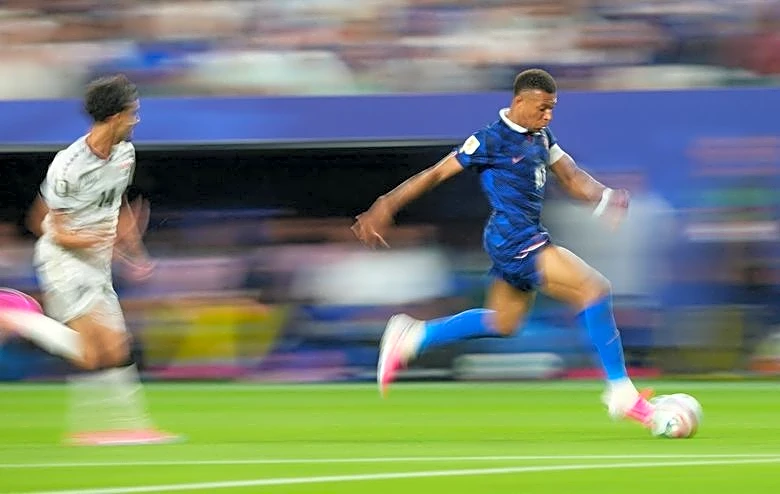 Soccer-Mbappe double sends France into knockout rounds after lengthy weather delay