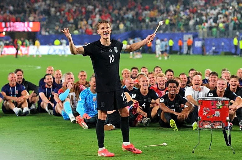 Soccer-Ecstatic Norway squad celebrate World Cup progress with Viking row