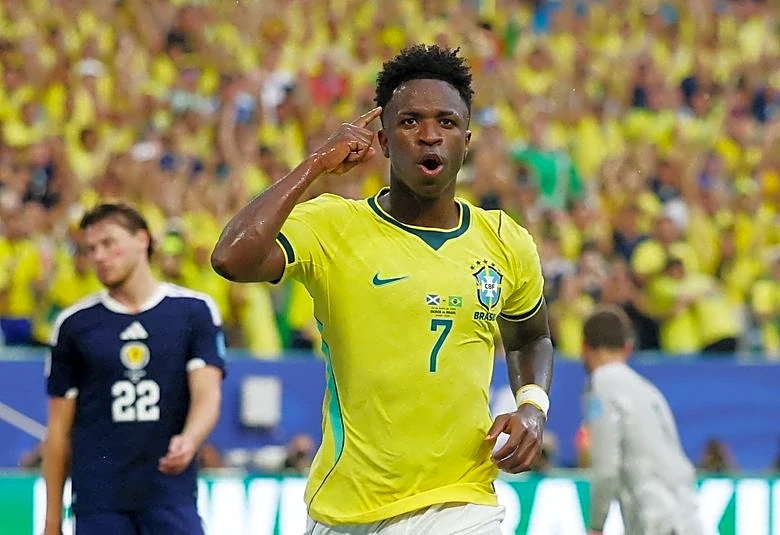 Soccer-Vinicius fires Brazil into World Cup knockouts with 3-0 win over Scotland