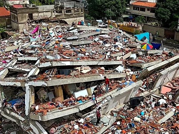 Between silence and shouts, rescuers dig for Venezuela twin quake survivors
