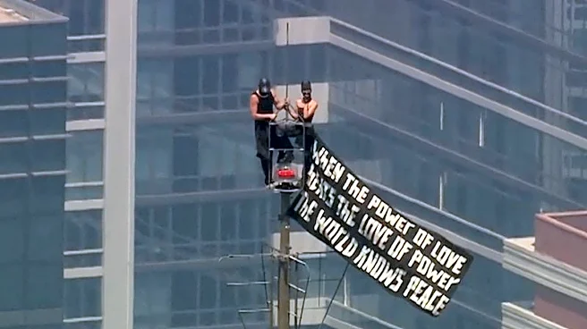 Russian daredevils unfurl banner atop New York's Empire State Building in proposal stunt