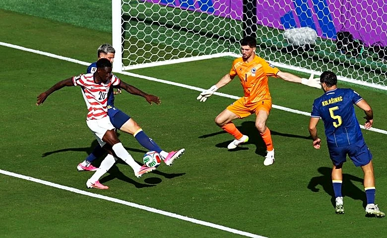 Soccer-Balogun goes from hero to suspended spectator as US advance