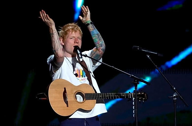 Soccer-Sheeran keeps up England tradition with World Cup camp visit